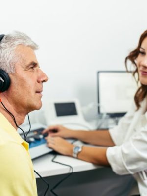 Senior man at medical examination or checkup in otolaryngologist's office
